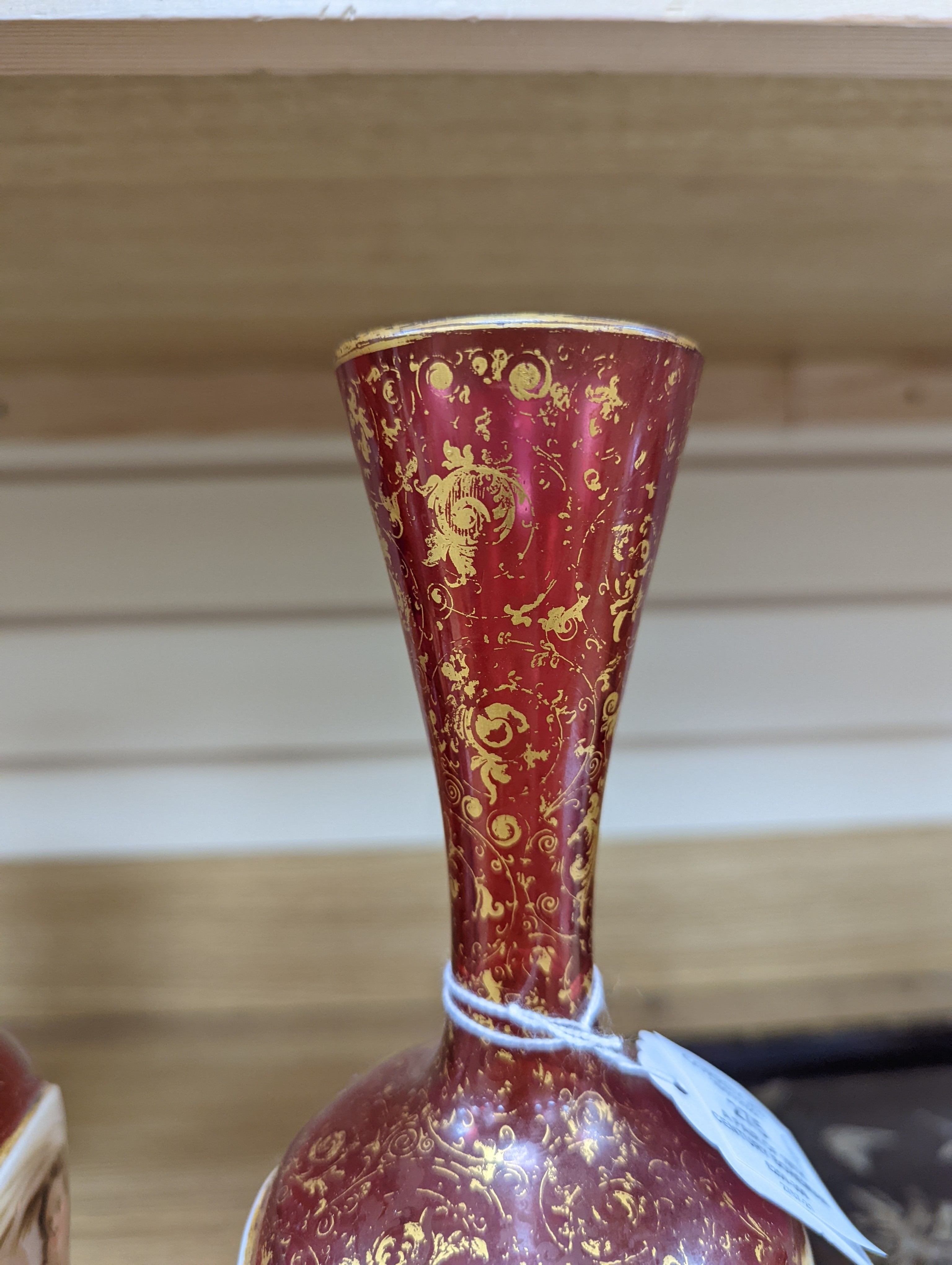 A pair of 19th century Bohemian enamelled and overlaid ruby glass vases 36cm